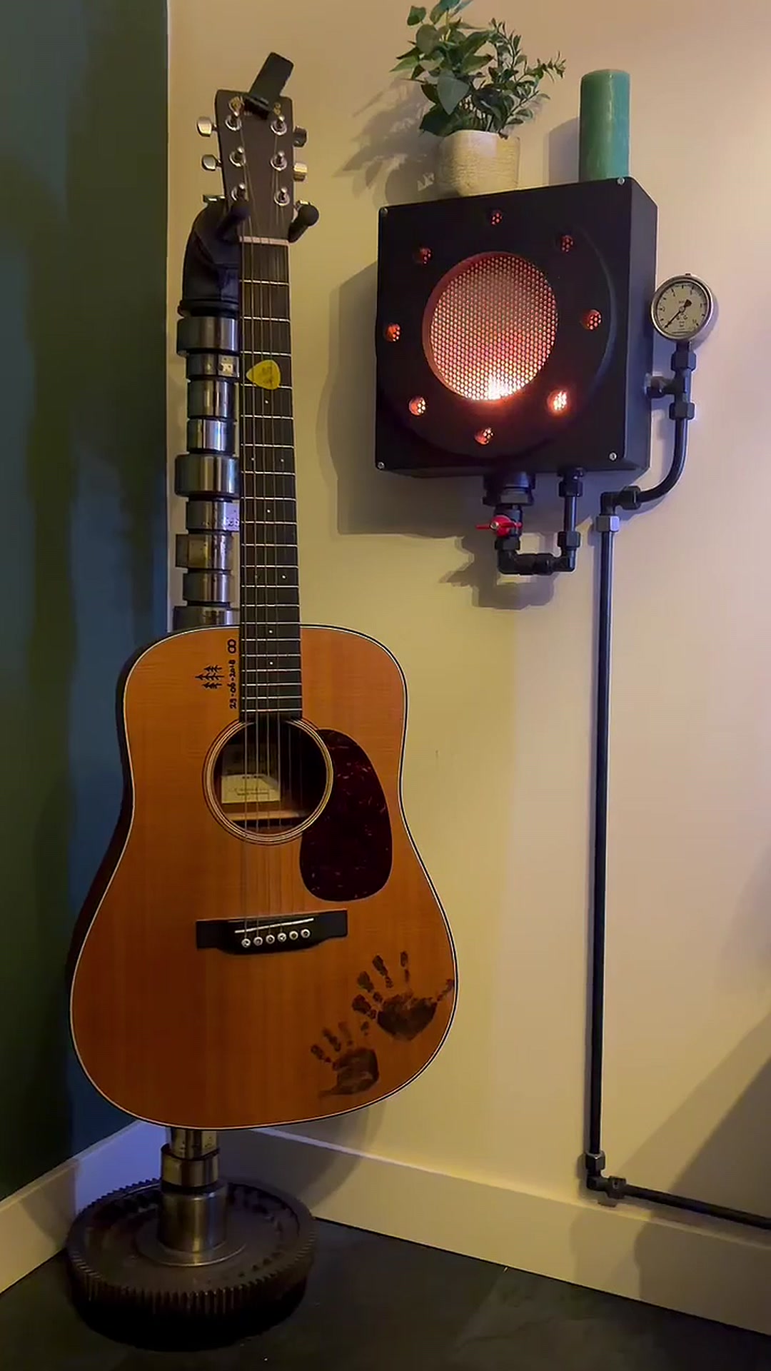 Fire-like light beside a guitar stand made from a ship camshaft